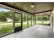 Large screened porch offering serene views of the outdoors and lush greenery at 1055 N Chickasaw Trl, Orlando, FL 32825