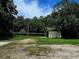 Backyard shed surrounded by lush greenery, offering ample storage space at 1055 N Chickasaw Trl, Orlando, FL 32825