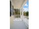 Balcony featuring stately columns, white railing, and neighborhood views beyond mature trees at 1115 Mosaic Dr, Celebration, FL 34747