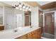 Bathroom features a dual sink vanity, large mirror, walk-in shower, and tile flooring at 1115 Mosaic Dr, Celebration, FL 34747