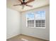 Bedroom features a ceiling fan, neutral carpet, and natural light from a window with blinds at 1115 Mosaic Dr, Celebration, FL 34747