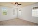Bedroom features carpet, a ceiling fan, and three windows providing lots of natural light at 1115 Mosaic Dr, Celebration, FL 34747