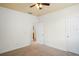 Bedroom features neutral carpet, a ceiling fan and access to the ensuite bathroom at 1115 Mosaic Dr, Celebration, FL 34747