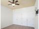 Bedroom features neutral carpet, a ceiling fan, and double closets at 1115 Mosaic Dr, Celebration, FL 34747
