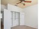 Bedroom features a closet with an organization system, carpet, and a ceiling fan at 1115 Mosaic Dr, Celebration, FL 34747