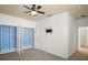 A bedroom with built-in closet organizers, ceiling fan, and neutral carpet offers move-in readiness at 1115 Mosaic Dr, Celebration, FL 34747