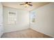 Bedroom features neutral carpet, two windows with blinds, and natural light at 1115 Mosaic Dr, Celebration, FL 34747