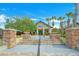 Beautiful clubhouse entrance with lush landscaping and stone accents under a bright blue sky at 1115 Mosaic Dr, Celebration, FL 34747