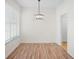 Bright dining area with modern lighting fixture and view to entryway at 1115 Mosaic Dr, Celebration, FL 34747