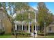 Charming two-story home with a welcoming front porch, pillars, and beautifully landscaped yard at 1115 Mosaic Dr, Celebration, FL 34747
