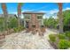 Cozy outdoor fireplace area with stone accents and comfortable rocking chairs at 1115 Mosaic Dr, Celebration, FL 34747