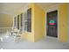 Beautiful porch with rocking chairs and view of front door with the colorful hello sign at 1115 Mosaic Dr, Celebration, FL 34747