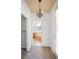 Hallway with views to walk-in closet, the ensuite bathroom with a tub, and an exterior door at 1115 Mosaic Dr, Celebration, FL 34747