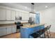 Kitchen features stainless steel appliances, a breakfast bar, granite countertops, and ample storage at 1115 Mosaic Dr, Celebration, FL 34747