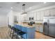 Modern kitchen features stainless steel appliances, granite countertops, and breakfast bar at 1115 Mosaic Dr, Celebration, FL 34747