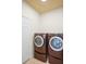 Convenient laundry room featuring side-by-side washer and dryer in a compact space at 1115 Mosaic Dr, Celebration, FL 34747