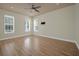 Sunlit living room with gleaming wood floors, ceiling fan, and multiple windows at 1115 Mosaic Dr, Celebration, FL 34747