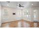 Bright living room with wood floors, ceiling fan, and natural light at 1115 Mosaic Dr, Celebration, FL 34747