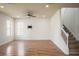 Open living room with wood floors, ceiling fan, and stairs at 1115 Mosaic Dr, Celebration, FL 34747