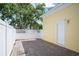 Private brick-paved patio area with white vinyl fence, offering seclusion and outdoor enjoyment at 1115 Mosaic Dr, Celebration, FL 34747