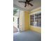 Inviting screened-in porch featuring a ceiling fan, neutral flooring, and views of the surrounding landscape at 1115 Mosaic Dr, Celebration, FL 34747