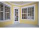 Covered outdoor space showcasing bright walls and large windows for natural light and neighborhood views at 1115 Mosaic Dr, Celebration, FL 34747