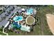 Aerial view of the community waterpark featuring pools, water slides, a playground, and green spaces at 1160 Kingsbarn St, Davenport, FL 33896