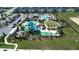 Aerial view of the community waterpark featuring pools, water slides, a playground, and green spaces at 1160 Kingsbarn St, Davenport, FL 33896