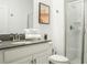 Bright bathroom features modern vanity, grey countertop, and walk-in shower with glass doors at 1160 Kingsbarn St, Davenport, FL 33896