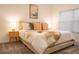 Cozy bedroom boasts natural light, a patterned blanket and throw pillows on a queen bed at 1160 Kingsbarn St, Davenport, FL 33896