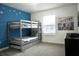 Charming bedroom featuring a bunk bed, Star Wars themed decor, and a bright blue accent wall at 1160 Kingsbarn St, Davenport, FL 33896