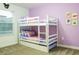 Bedroom with a white bunk bed and purple walls at 1160 Kingsbarn St, Davenport, FL 33896