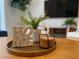 Close up of a decorative coffee table with a home decor, plants, and coasters on a tray at 1160 Kingsbarn St, Davenport, FL 33896