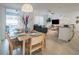 Open concept dining room with seating for four, a view of the living room, and patio access at 1160 Kingsbarn St, Davenport, FL 33896
