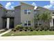Contemporary two-story townhouse featuring stone accents, well-kept landscaping, and a modern architectural style at 1160 Kingsbarn St, Davenport, FL 33896
