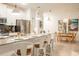 Bright, open kitchen featuring a large island with seating, stainless steel appliances, and modern pendant lighting at 1160 Kingsbarn St, Davenport, FL 33896