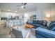 Open-concept living area with ample seating, a ceiling fan and adjoins the kitchen at 1160 Kingsbarn St, Davenport, FL 33896