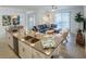 Open floor plan showcases a living room, dining area, and kitchen with modern finishes and ample natural light at 1160 Kingsbarn St, Davenport, FL 33896