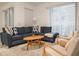 Cozy living room featuring a comfortable blue couch, matching throw pillows, an area rug, and lots of natural light at 1160 Kingsbarn St, Davenport, FL 33896