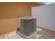 Close-up of a modern AC unit on a brick paver patio with a white privacy fence at 13758 Daniels Landing Cir, Winter Garden, FL 34787