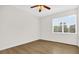 Bedroom featuring wood-look floors, ceiling fan and a large window at 13758 Daniels Landing Cir, Winter Garden, FL 34787