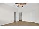 Bright bedroom featuring ceiling fan, closet and views of the stairwell at 13758 Daniels Landing Cir, Winter Garden, FL 34787