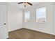 Bright bedroom featuring wood-look flooring and two large windows at 13758 Daniels Landing Cir, Winter Garden, FL 34787