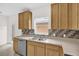 Well-lit kitchen with stainless steel appliances, light wood cabinetry, and tiled backsplash at 13758 Daniels Landing Cir, Winter Garden, FL 34787