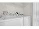 Laundry room featuring side-by-side washer and dryer with wire shelving at 13758 Daniels Landing Cir, Winter Garden, FL 34787