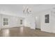 Open living room boasts wood-look floors and half-bath entrance at 13758 Daniels Landing Cir, Winter Garden, FL 34787