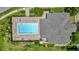 Aerial shot showcases a large, rectangular community pool surrounded by lounge chairs and well-maintained landscaping at 13758 Daniels Landing Cir, Winter Garden, FL 34787