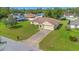 Aerial view of a home with well-maintained lawn and landscaping in a residential neighborhood at 14091 Sw 32Nd Terrace Rd, Ocala, FL 34473