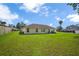 Spacious backyard with a well-maintained lawn and an exterior view of the house at 14091 Sw 32Nd Terrace Rd, Ocala, FL 34473