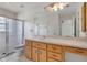 Bathroom featuring a walk-in shower, a neutral vanity, and a large mirror for added brightness at 14091 Sw 32Nd Terrace Rd, Ocala, FL 34473
